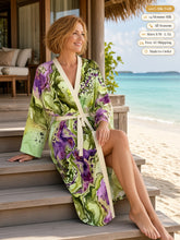 Load image into Gallery viewer, Woman sitting on bungalow steps by a lagoon in the Sunken Atlantis silk peignoir, classic style with ivory trim and tie