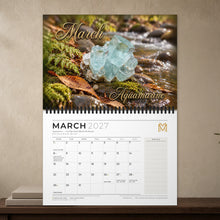 Load image into Gallery viewer, Calendar open at March 2027: aquamarine image above a white date grid with public holidays and a notes column
