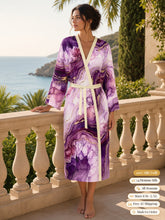Load image into Gallery viewer, Woman standing on a seaside terrace in the Purple Heartstone silk peignoir, classic style with ivory trim and tie
