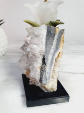 Load image into Gallery viewer, Peruvian Rhodonite Hummingbird on Quartz Cluster Base On White Jade Flower with Serpentine Leaves
